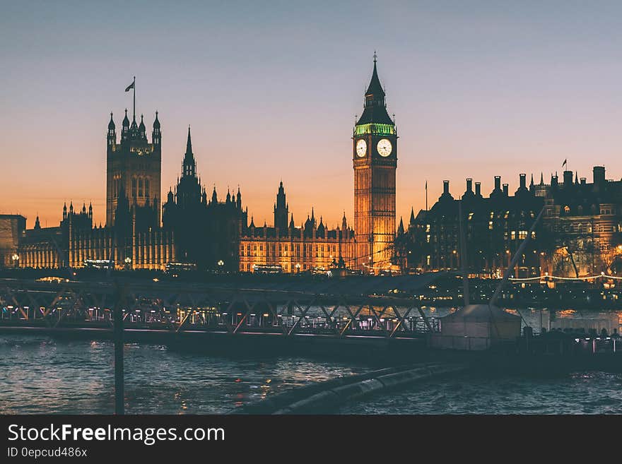 Big Ben clock tower on Parliament buildings along River Thames at sunset. Big Ben clock tower on Parliament buildings along River Thames at sunset.