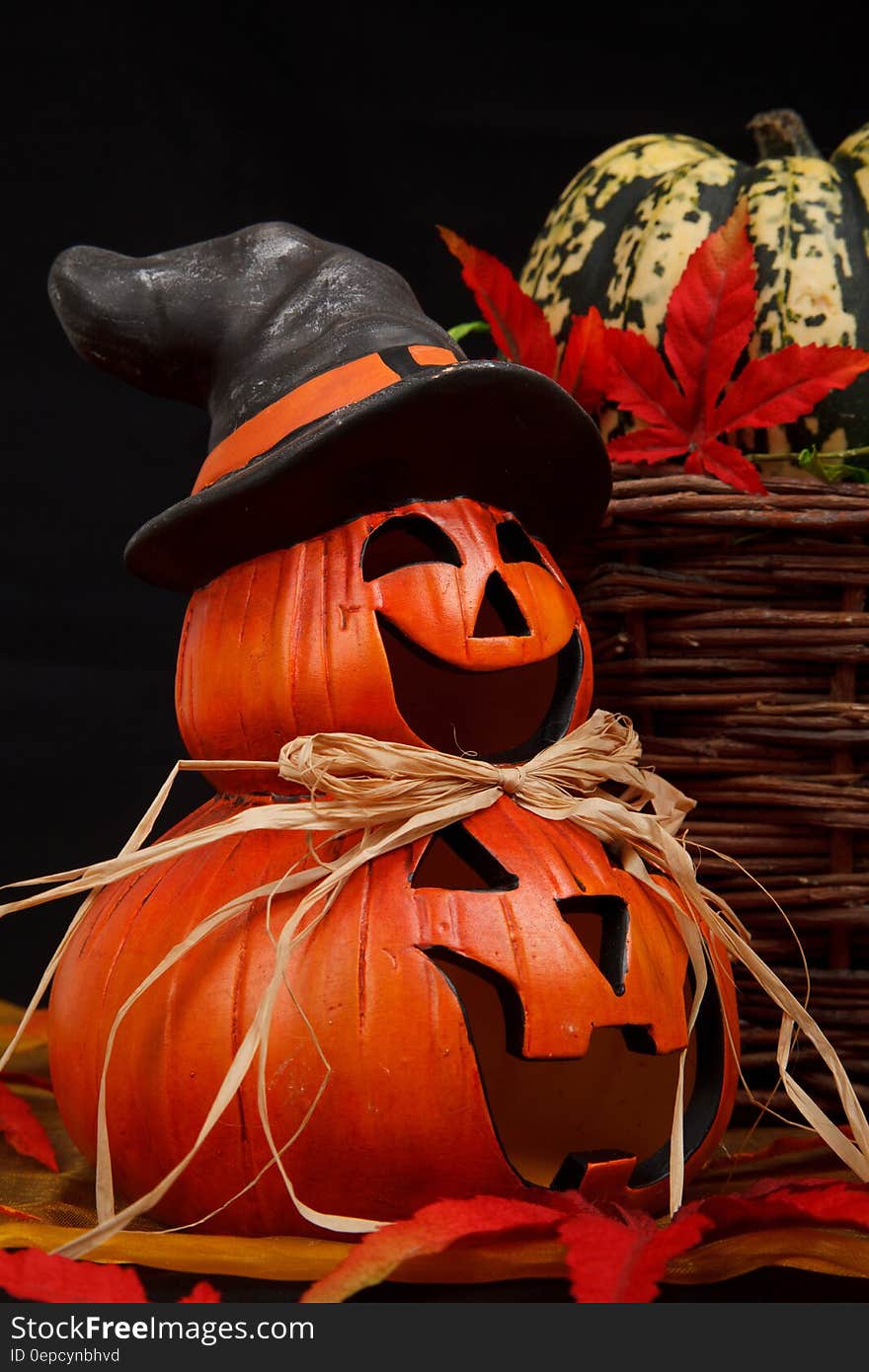 Fall still life of pumpkins decorated at Jack O'Lanterns with hat and fall foliage. Fall still life of pumpkins decorated at Jack O'Lanterns with hat and fall foliage.