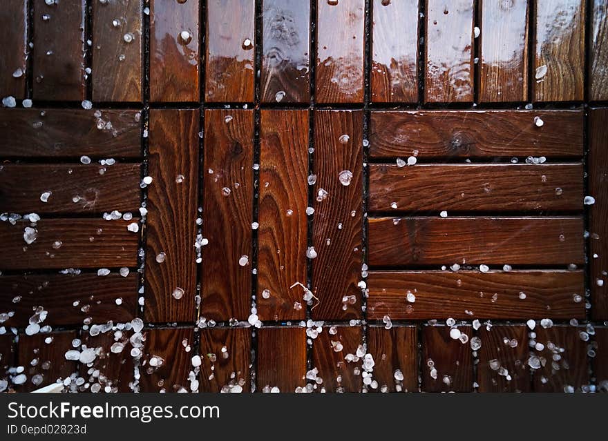 Shiny background created by wet woodblock flooring with hailstones or small ice pellets. Shiny background created by wet woodblock flooring with hailstones or small ice pellets.