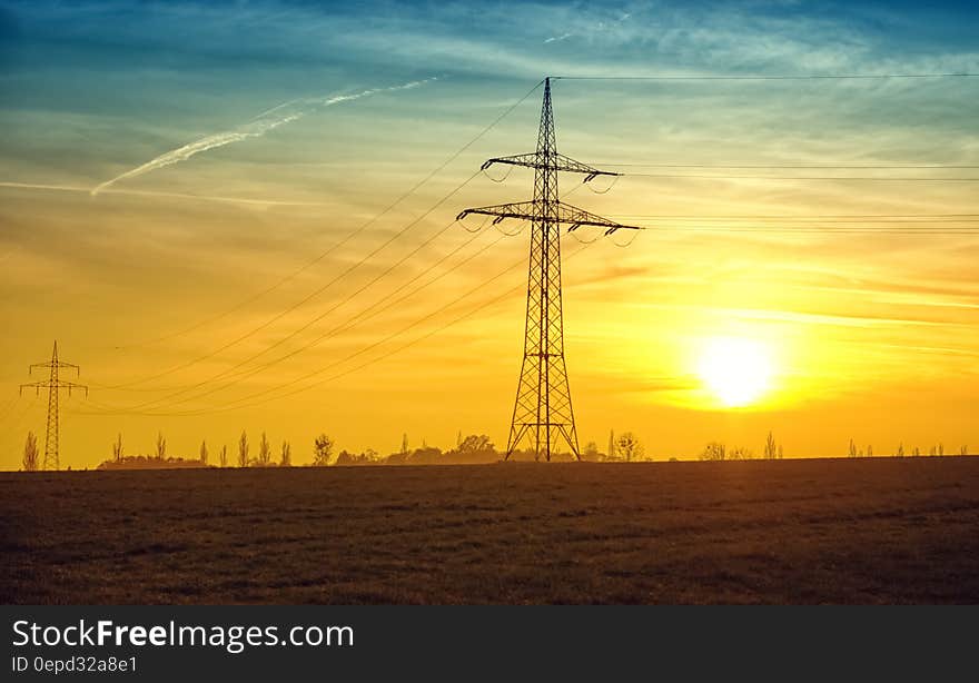 Electric stanchion in rural field at sunset. Electric stanchion in rural field at sunset.