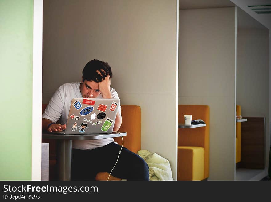 Man in White Shirt Using Macbook Pro