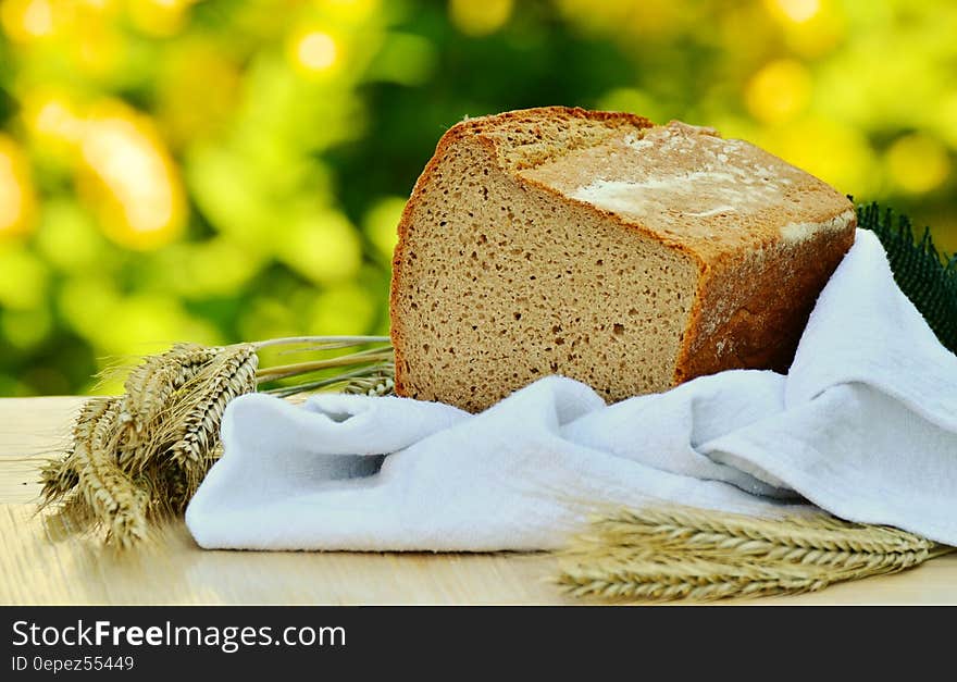 Brown Loft Bread in White Textile on Beige Table