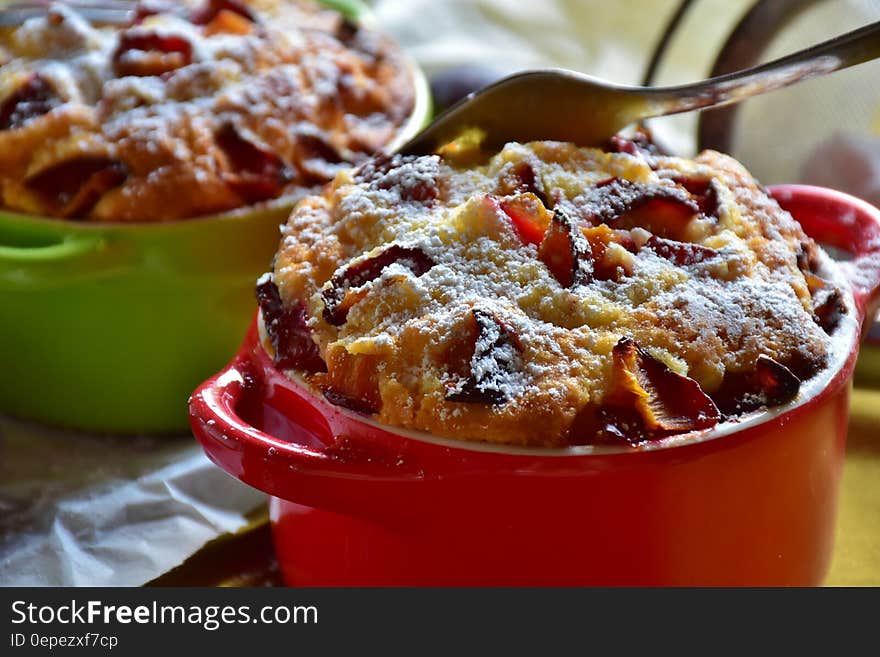 Stainless Steel Fork on Top of Brown Cooked Pastry on Top of Red Ceramic Mug