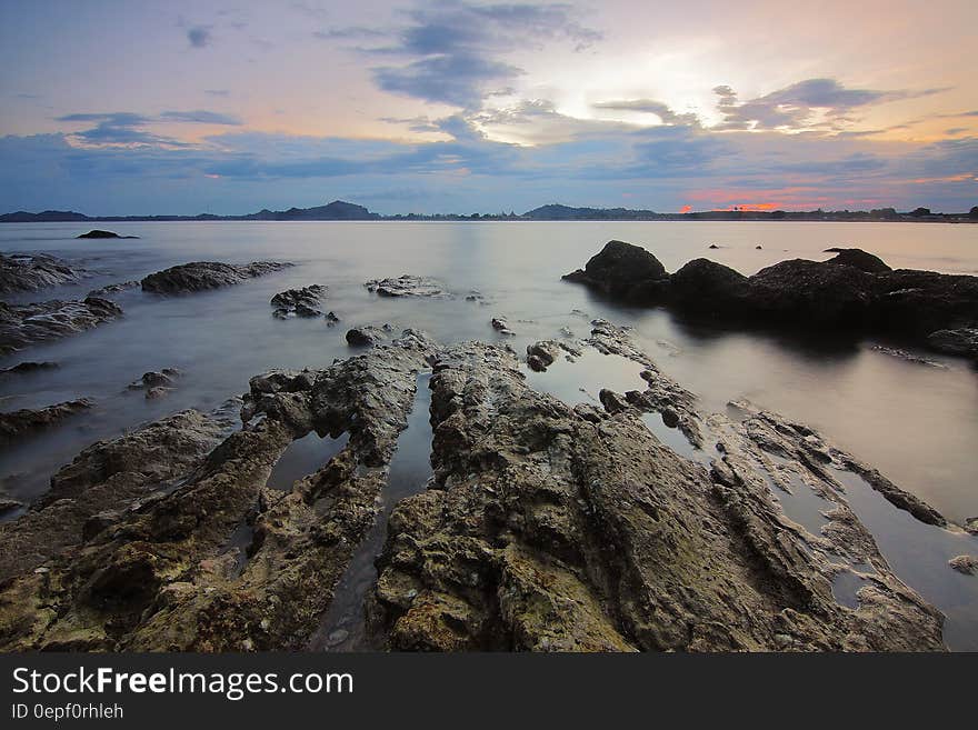 Top View of Beach and Rocks Under Grey Cloudy Sky