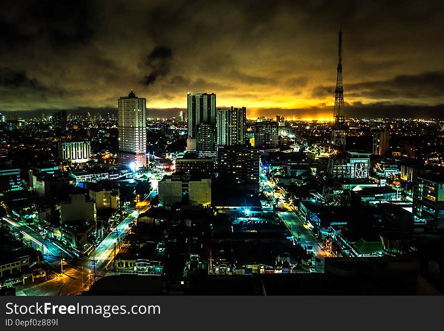 Landscape Painting of High Rise Building Under Brown Sky