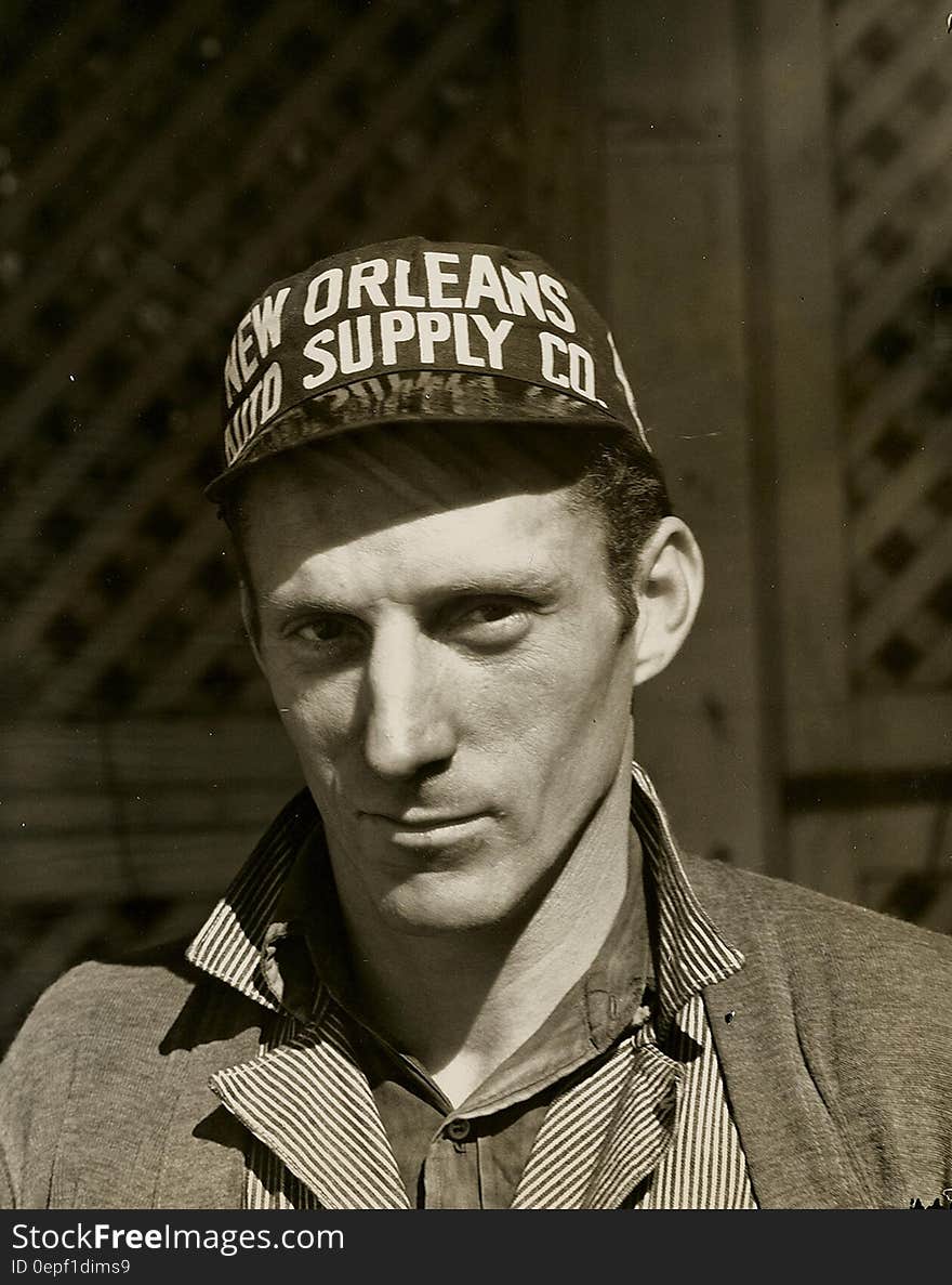 Black and White Photo of Man Wearing New Orleans Supply Hat