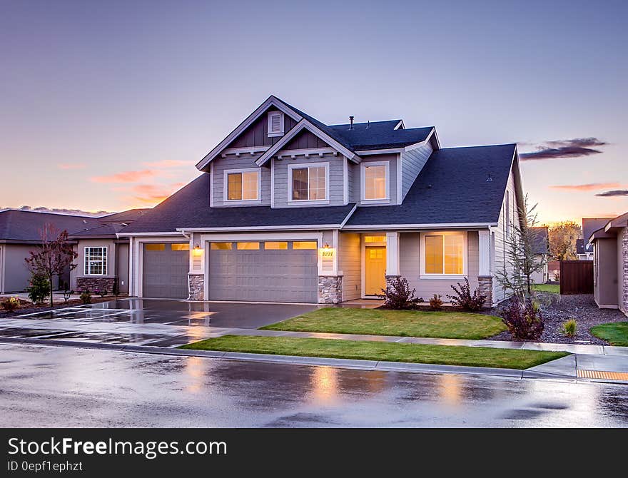 Blue and Gray Concrete House With Attic during Twilight