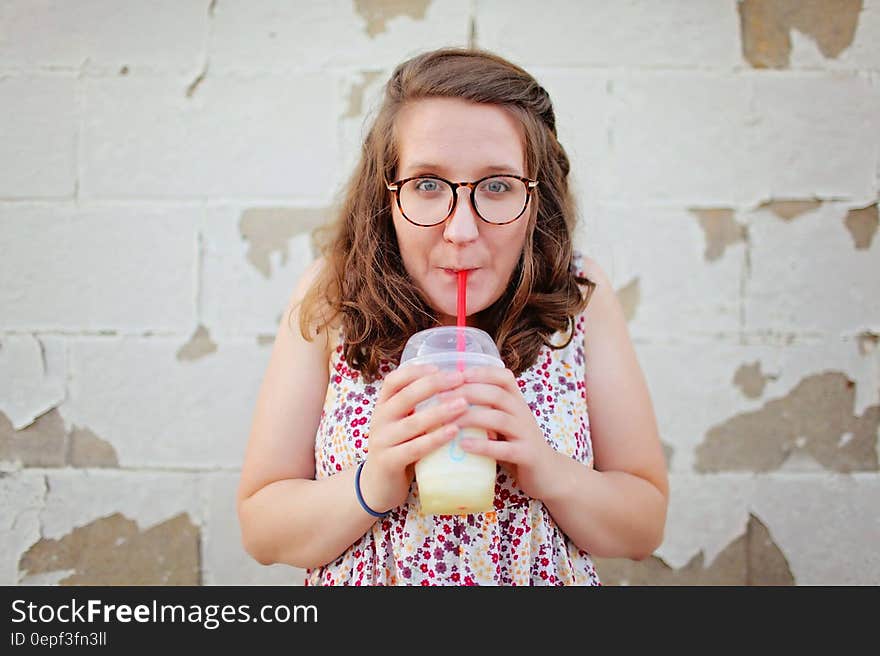 Woman in Black Framed Eyeglasses Drinking