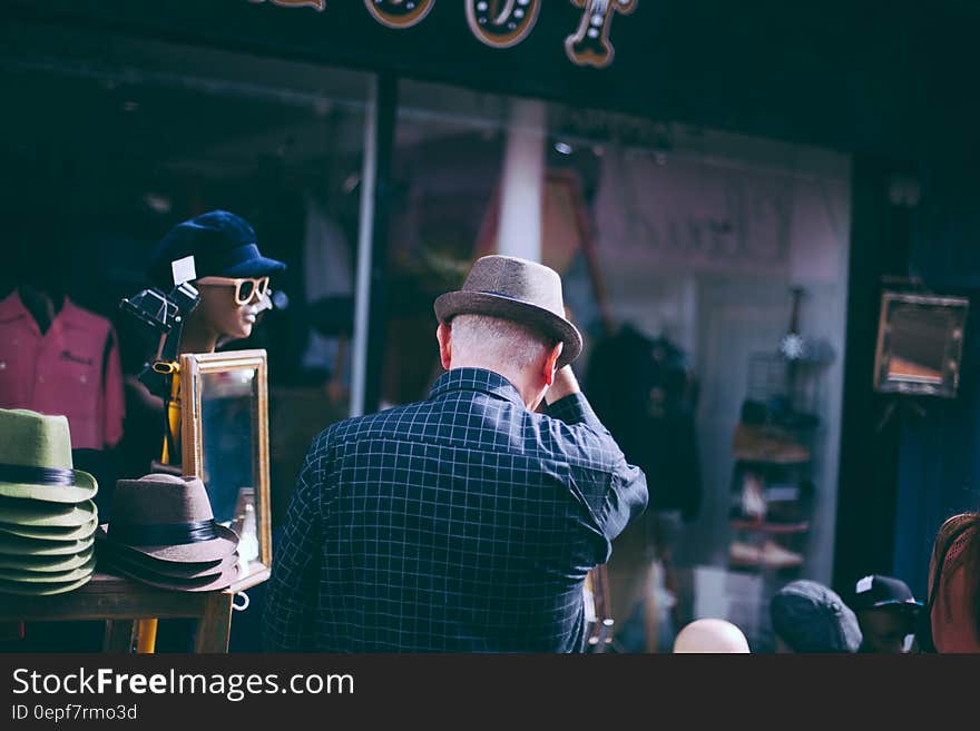 Man in Checkered Long Sleeve and Fedora Hat