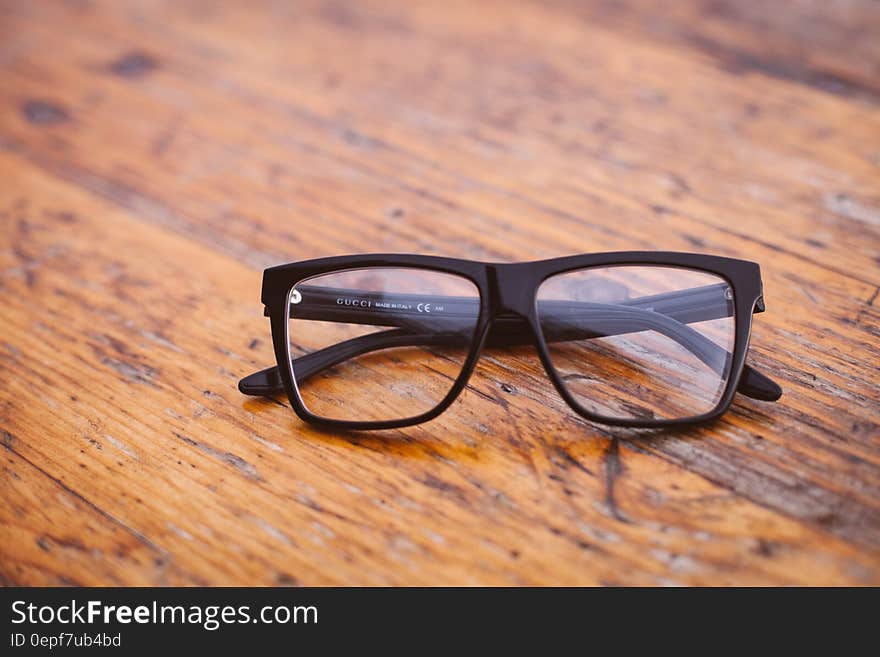 Black Frame Wayfarer Eyeglasses on Brown Wooden Surface