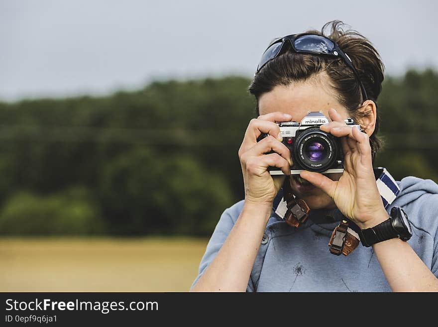 Man Holding Gray and Black Dslr Camera