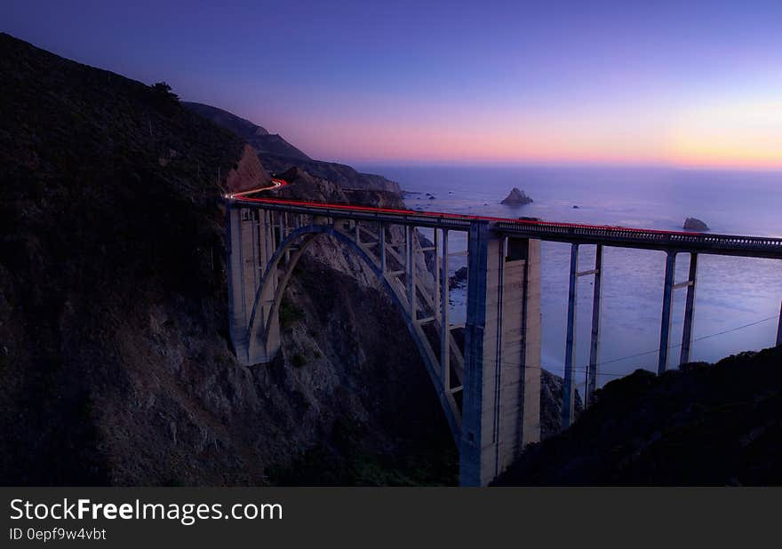 Time Lapse Photography of Cars Running on Bridge Near Ocean