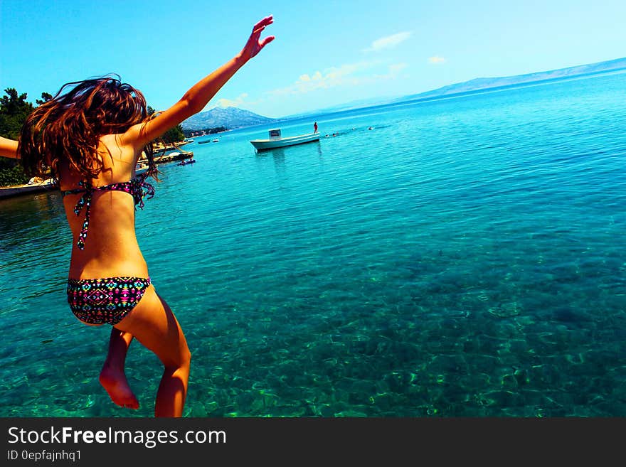 Woman Wearing Bikini Jumping to the Beach