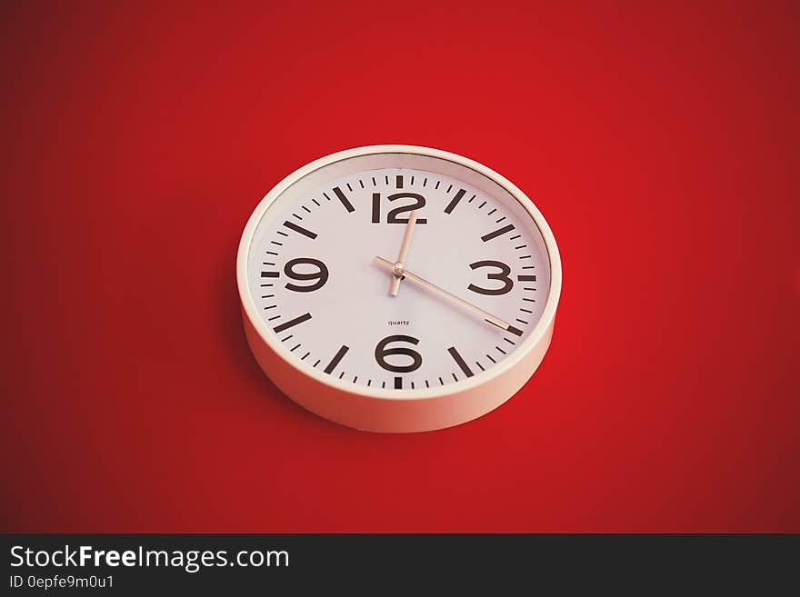 Close up of clock on red interior wall. Close up of clock on red interior wall.