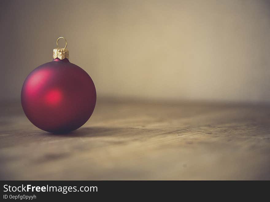 Red Christmas Bauble in Selective Focus Photography