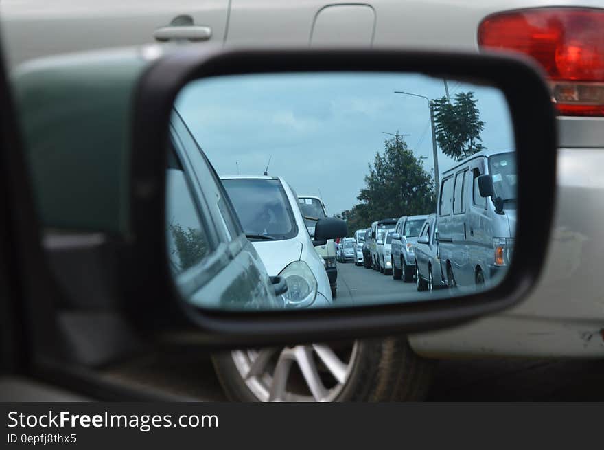 Car Side Mirror Showing Heavy Traffic