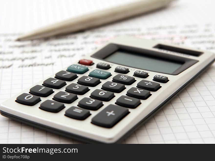 White and Black Desk Calculator on White Graphing Paper