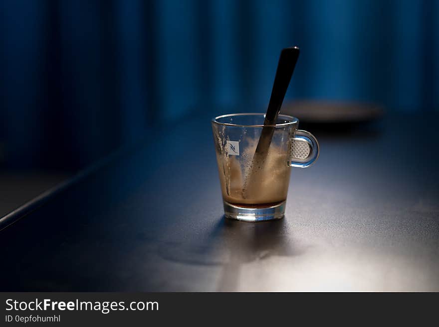 Black Stirring Rod on Clear Glass Cup