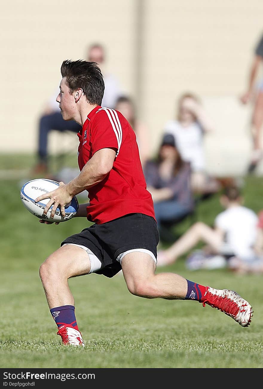 Man Playing Rugby at Daytime