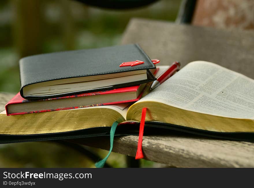 Black Hardbound Book on the Top of the Book