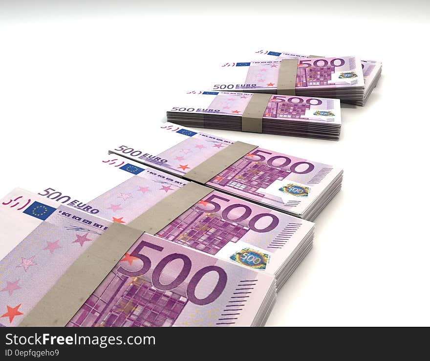 500 Euro notes in bundles on white.