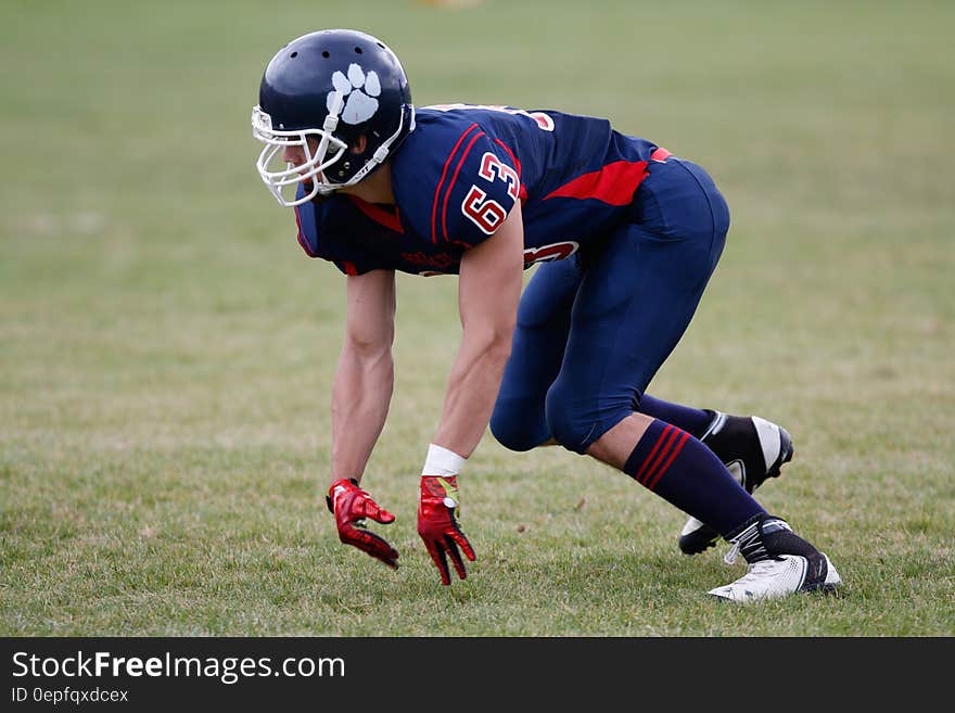 Man in Blue American Football Suit on Green Grass Field