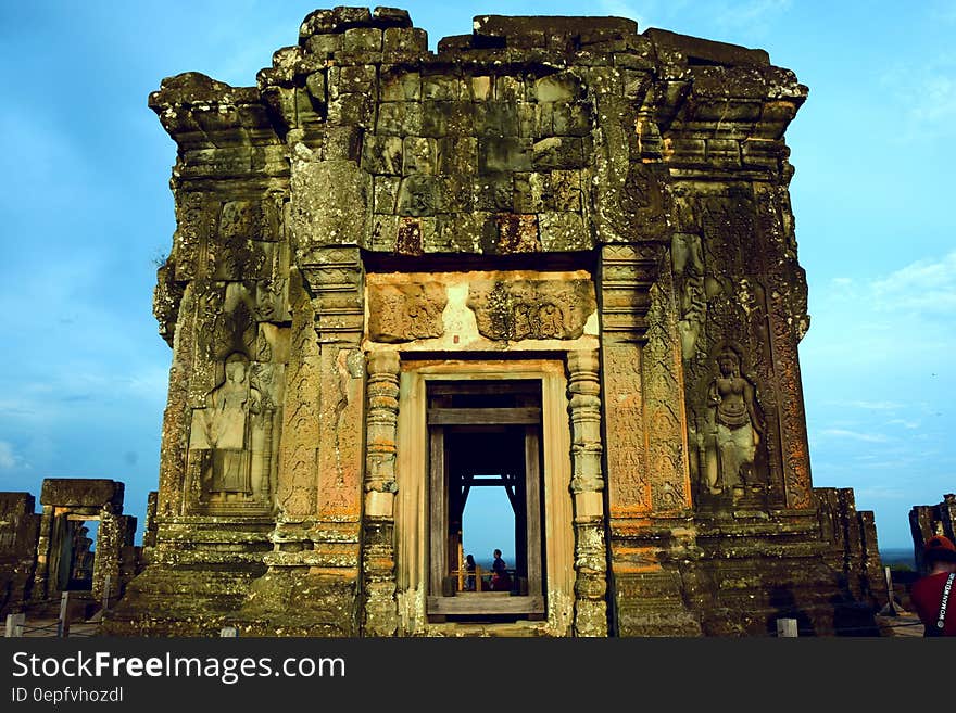 Exterior of ancient stone temple ruins against blue skies. Exterior of ancient stone temple ruins against blue skies.