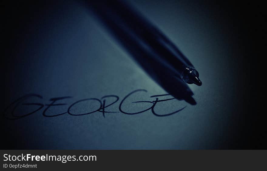 The name "George" written on the surface or a tablet with a pen or a stylus next to it. The name "George" written on the surface or a tablet with a pen or a stylus next to it.