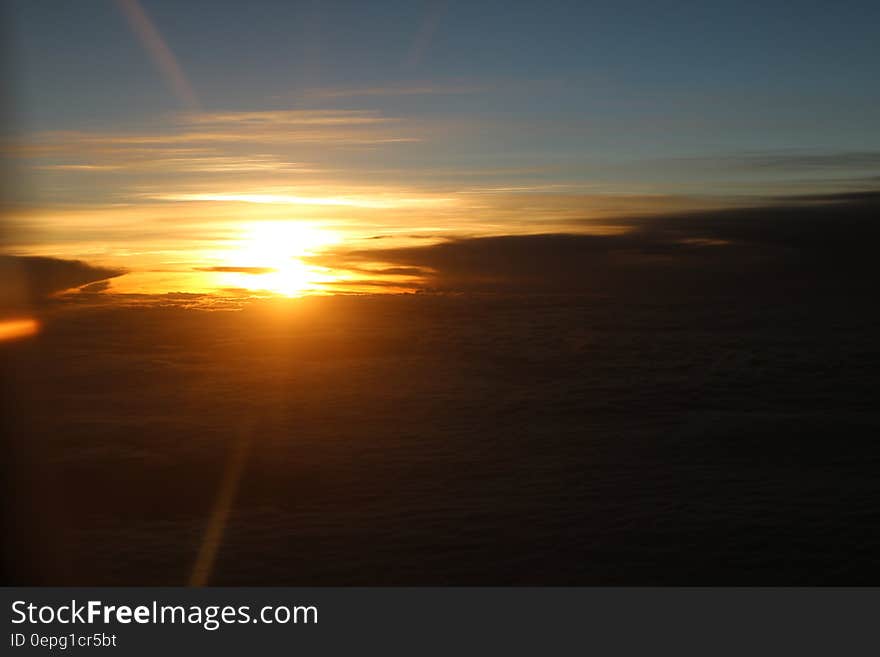 Sunset behind dark clouds in the sky.