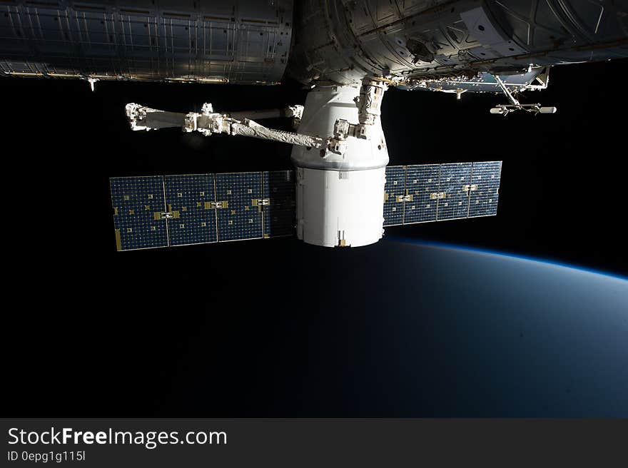 SpaceX COTS Dragon connected to the ISS by Canadarm2. SpaceX COTS Dragon connected to the ISS by Canadarm2.