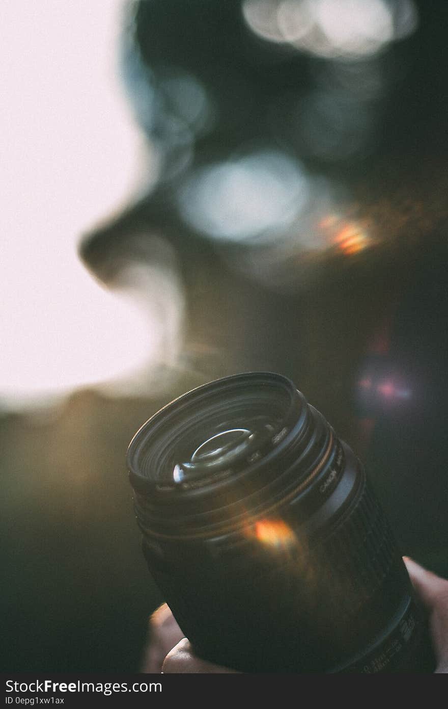 A camera lens with a bokeh background.