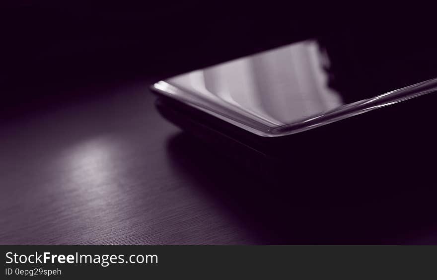 A close up of a smartphone on a table. A close up of a smartphone on a table.