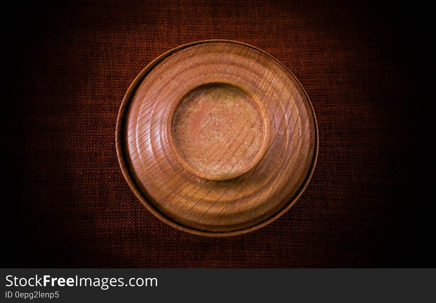 An old wooden bowl on wood background. An old wooden bowl on wood background.