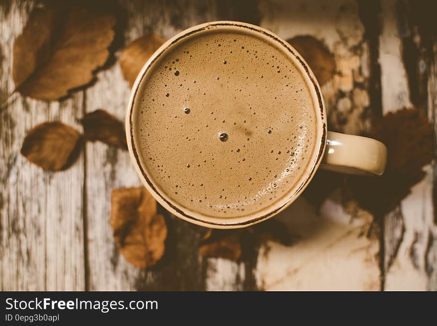 White Ceramic Mug over Brown Table