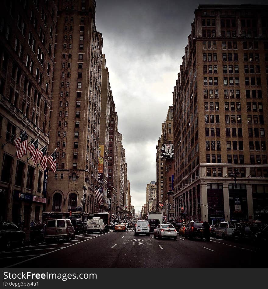 Traffic on streets of modern American street between skyscrapers against overcast skies. Traffic on streets of modern American street between skyscrapers against overcast skies.