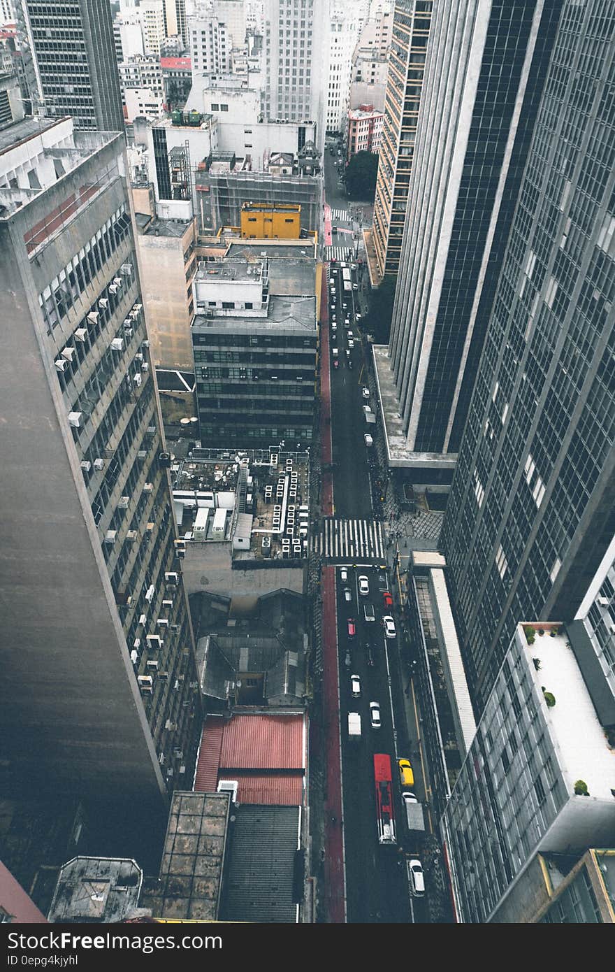 Aerial view down skyscrapers of traffic on city streets on sunny day. Aerial view down skyscrapers of traffic on city streets on sunny day.