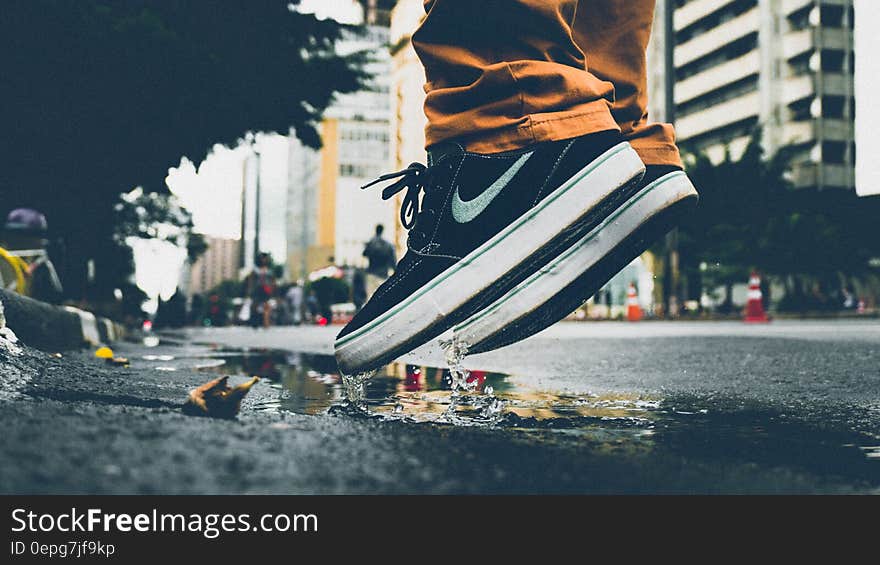 Man Jumping On Puddle Of Water