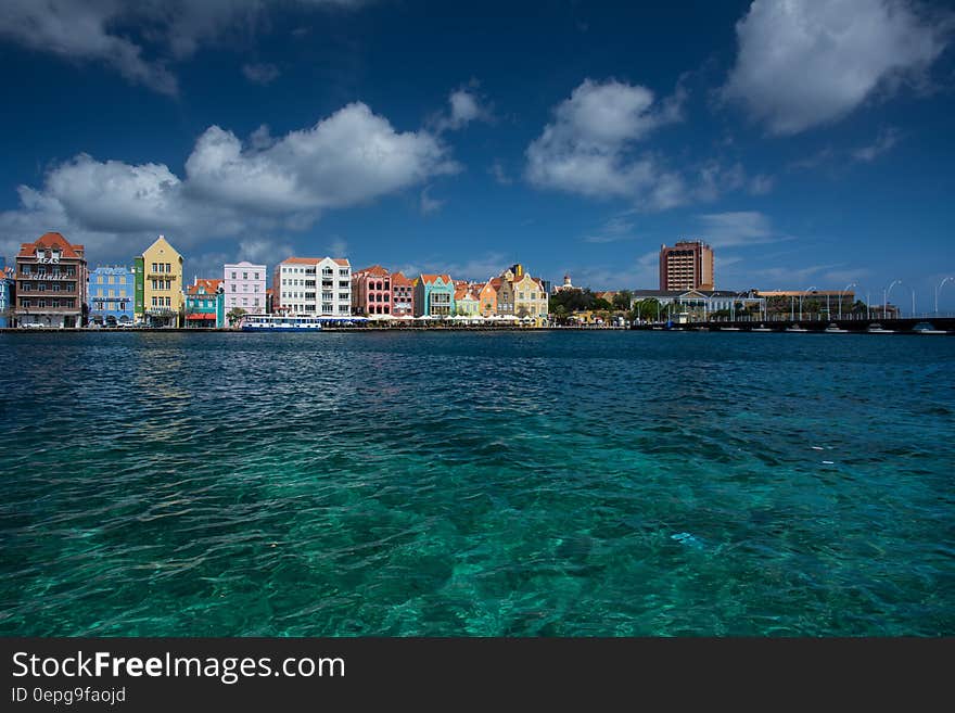 Colorful buildings along waterfront in Willemstad, Curacao in Dutch Antilles against blue skies. Colorful buildings along waterfront in Willemstad, Curacao in Dutch Antilles against blue skies.