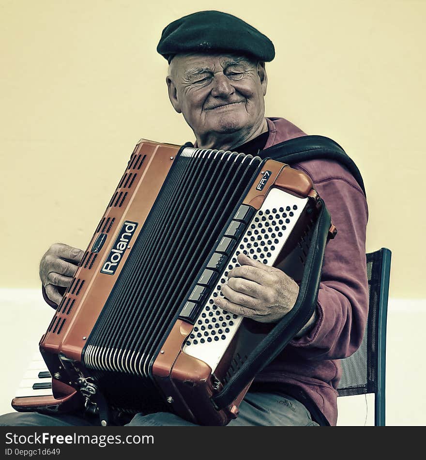 Man Sitting Playing Accordion