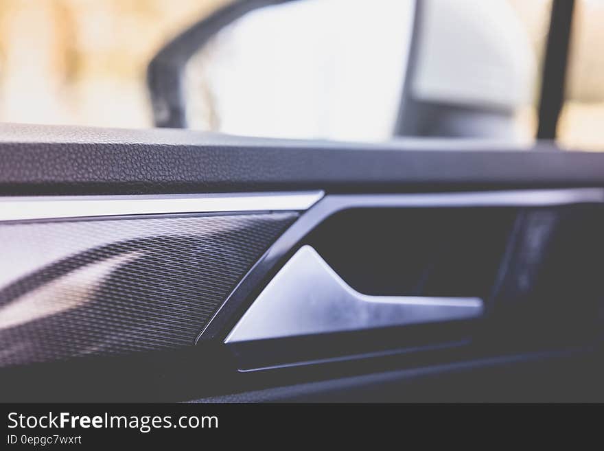 Interior view of handle and glass window in motor car. Interior view of handle and glass window in motor car.