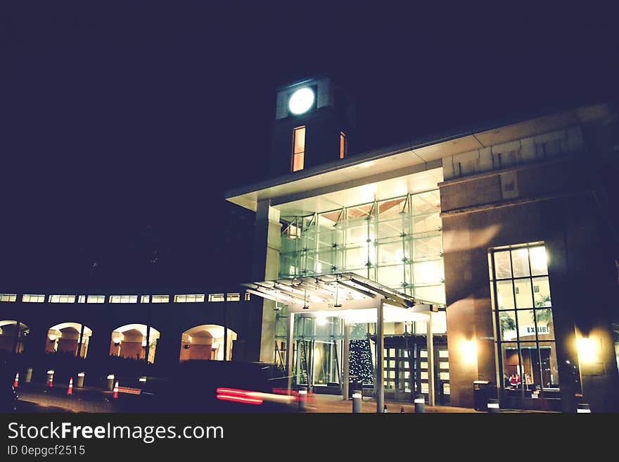 Exterior of modern building illuminated at night against dark skies.