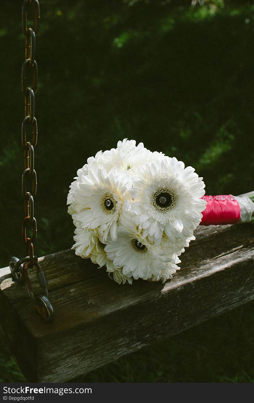 White Bouquet Flower on Brown and Grey Metal Outdoor Swing