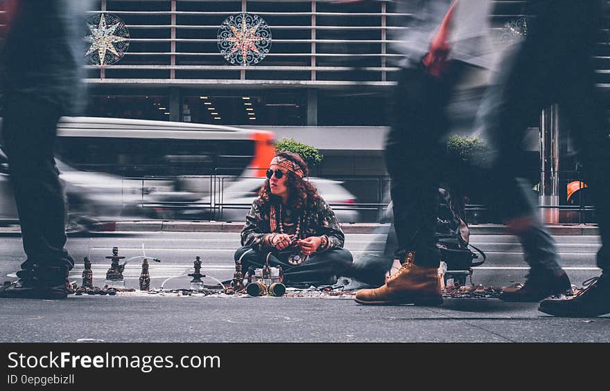 Man in hipster dress selling wares on city streets. Man in hipster dress selling wares on city streets.