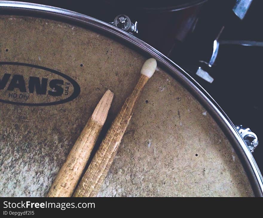 Close up of broken drumstick on drum head.