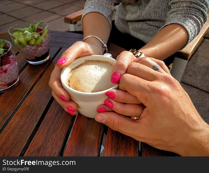 Midsection of Woman Holding Coffee Cup on Table