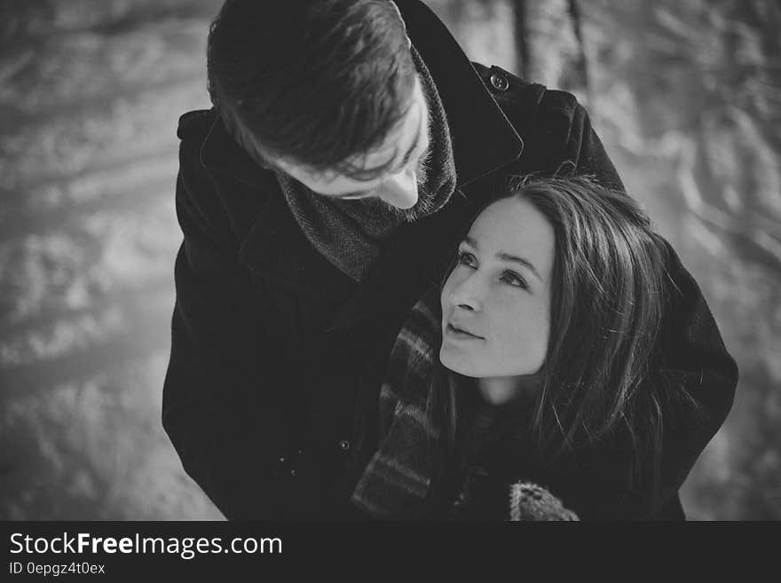 Man Hugging Smiling Woman from Behind