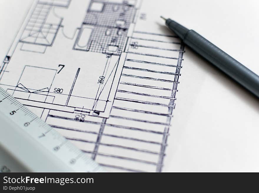 An architectural drawing of a building with scale ruler and marker. An architectural drawing of a building with scale ruler and marker.