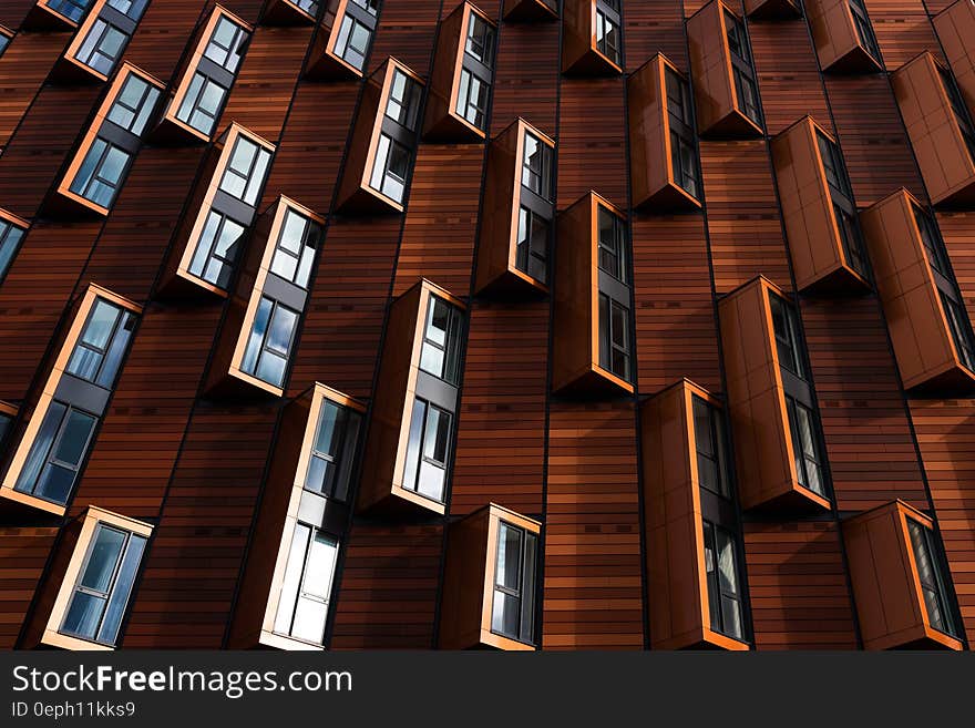 Windows reflecting sunlight outside brown modern building. Windows reflecting sunlight outside brown modern building.