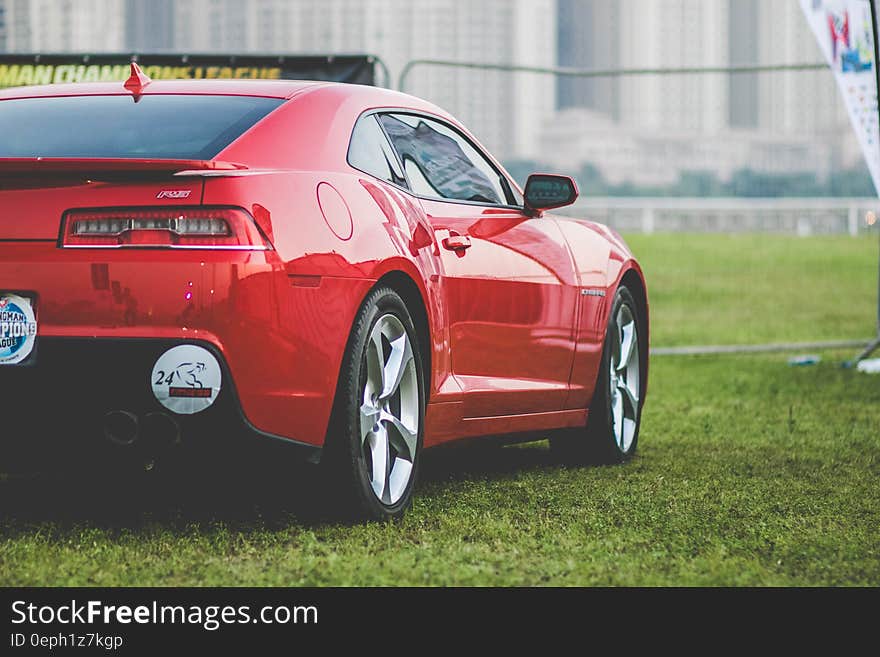 A red Chevrolet Camaro R5 parked on grass.