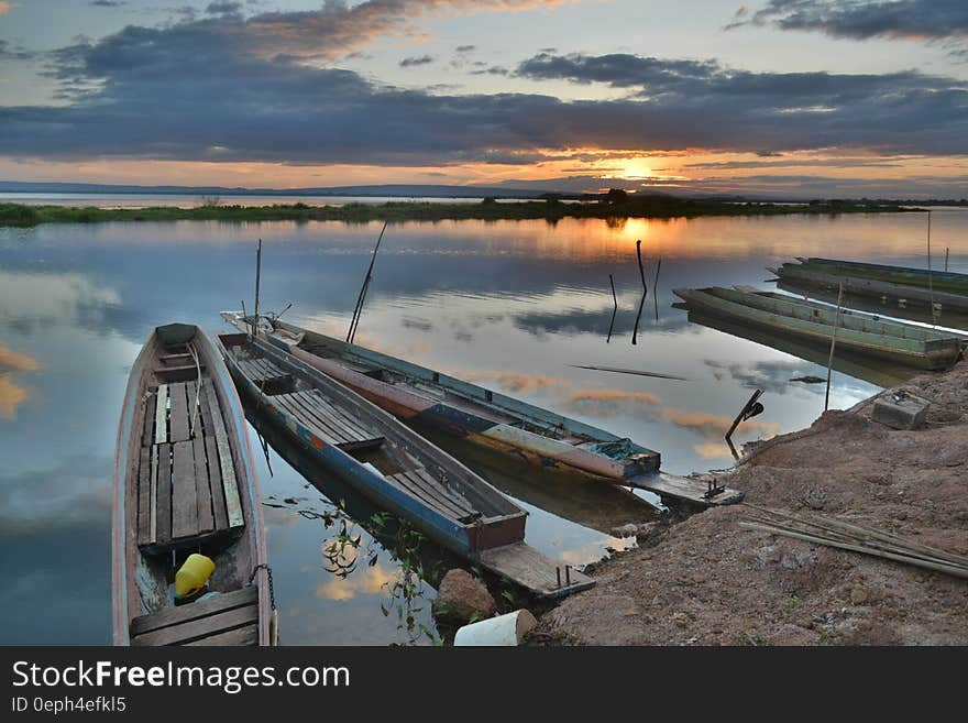 Canoe on Seashore during Sunset